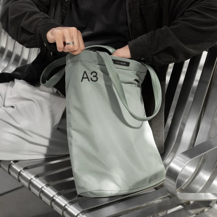 Person using a tote on a bench