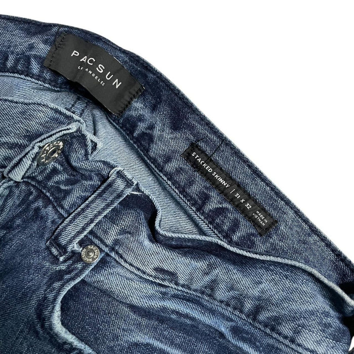 Distressed blue denim jeans