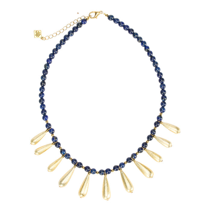 Necklace with blue beads and gold teardrop pendants on a white background