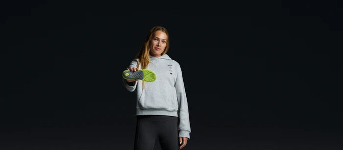 Person holding a Superfeet's SuperRev Max Personalized Insole.