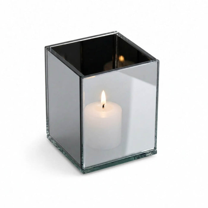 Square mirrored candle holder with a glowing white votive on a white background