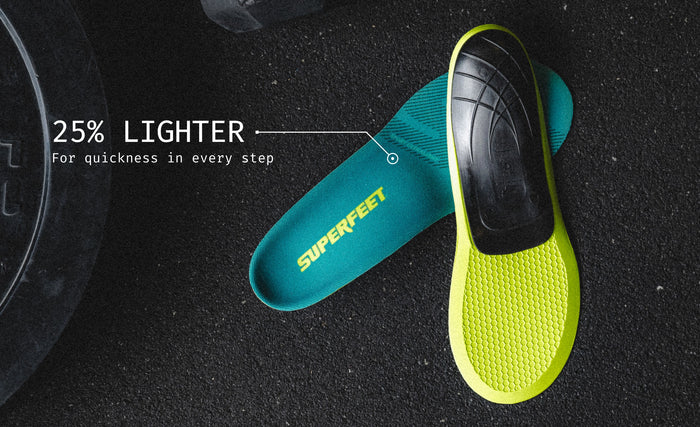 A Superfeet's Sport Ultralight Insole against a black floor. Text reads "25% Lighter For quickness in every step"