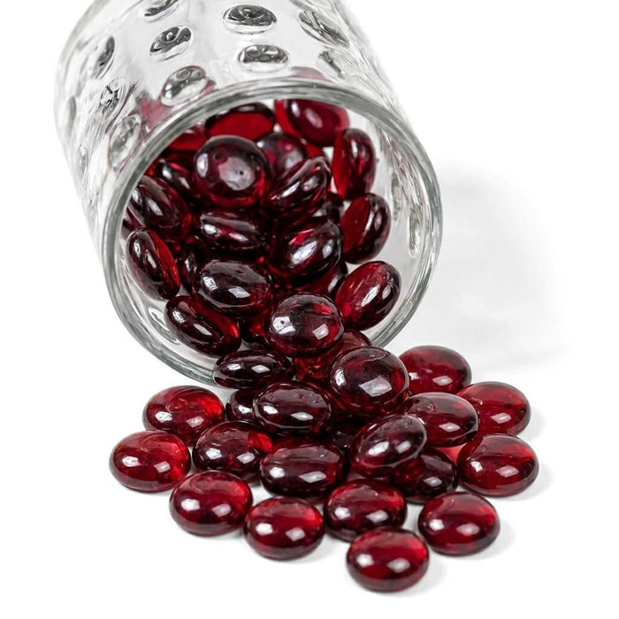 Ruby red vase gems spilling from a glass jar
